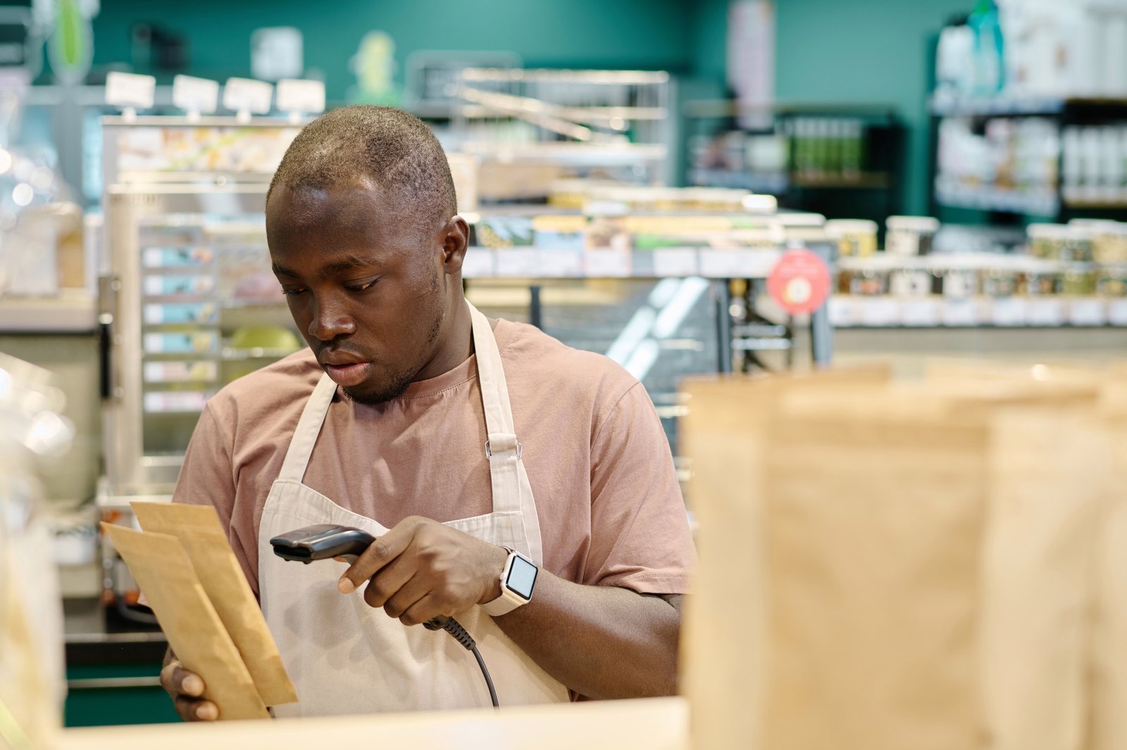 Worker scanning goods in supermarket